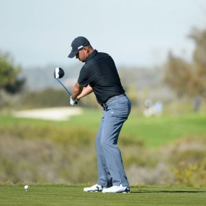 Golf Swing Basics Image Tip: Gary Woodland's back of hand leads the club in takeaway before the hip turn in golf swing